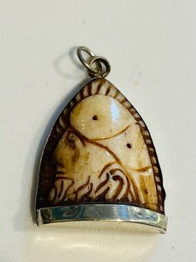 Carved bone pendant, often referred to as an India Pendant or a Hindu Amulet